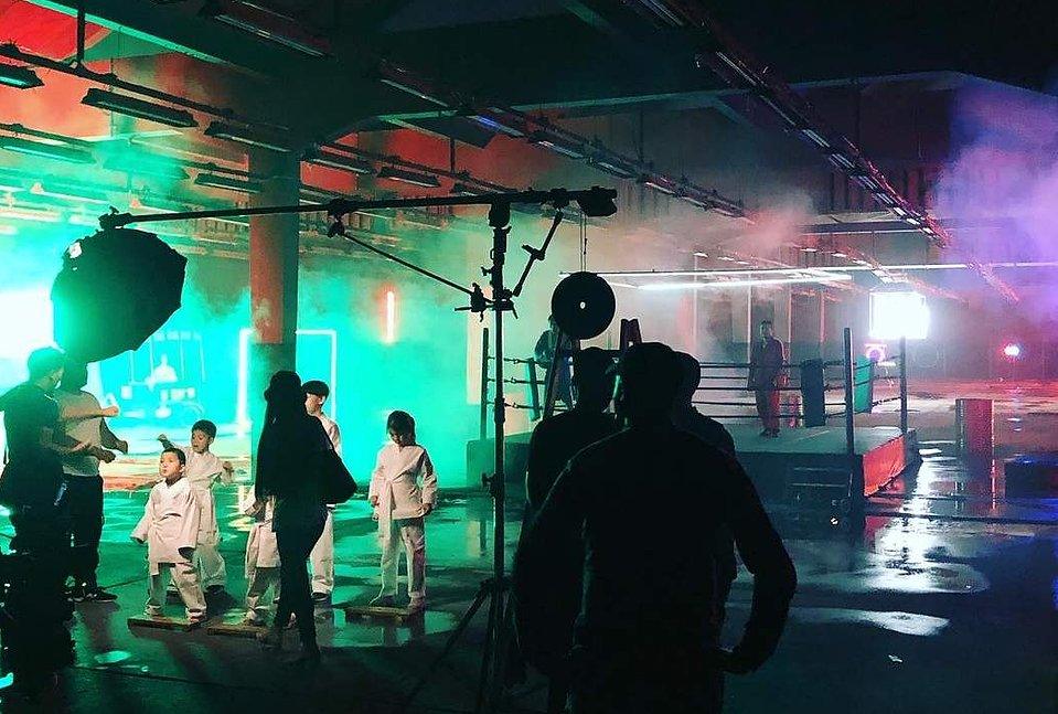 Crew lighting a studio set during a shoot